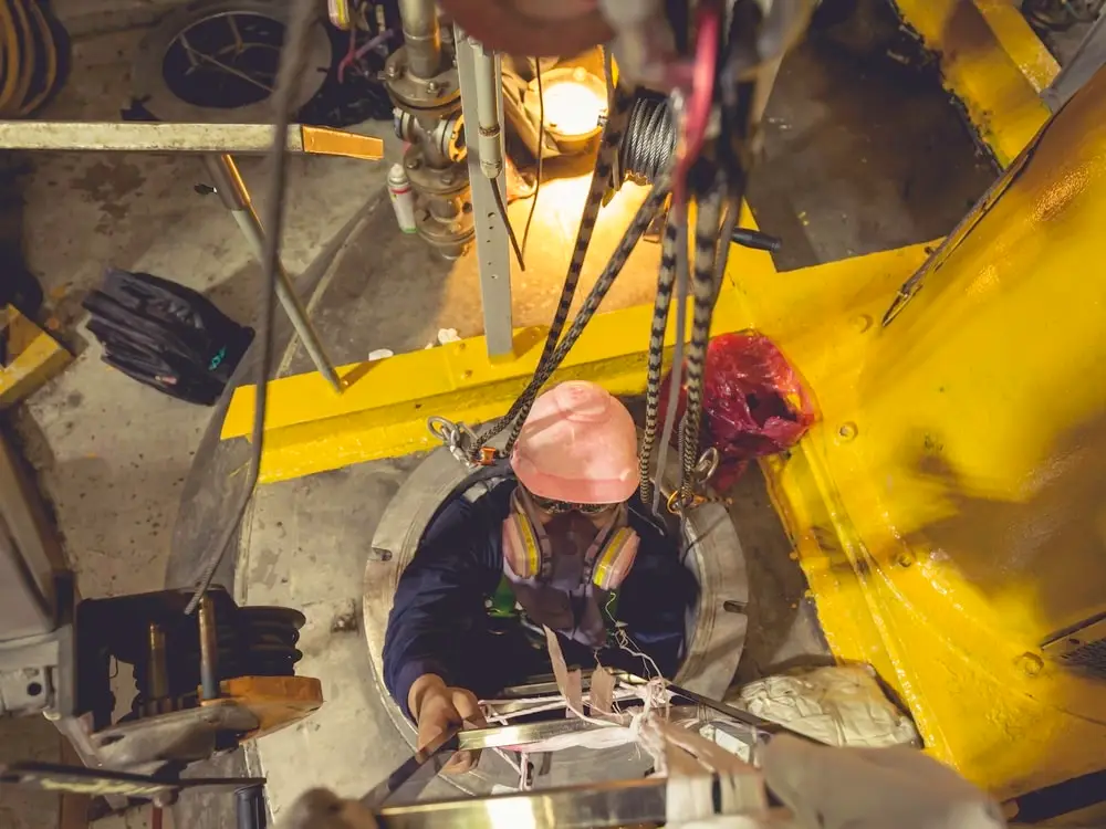 Trained technician descending safely into a confined space