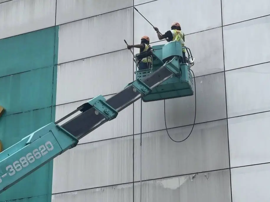 Commercial facade painting by rope access technicians