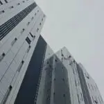 Rope access technician maintaining a building facade