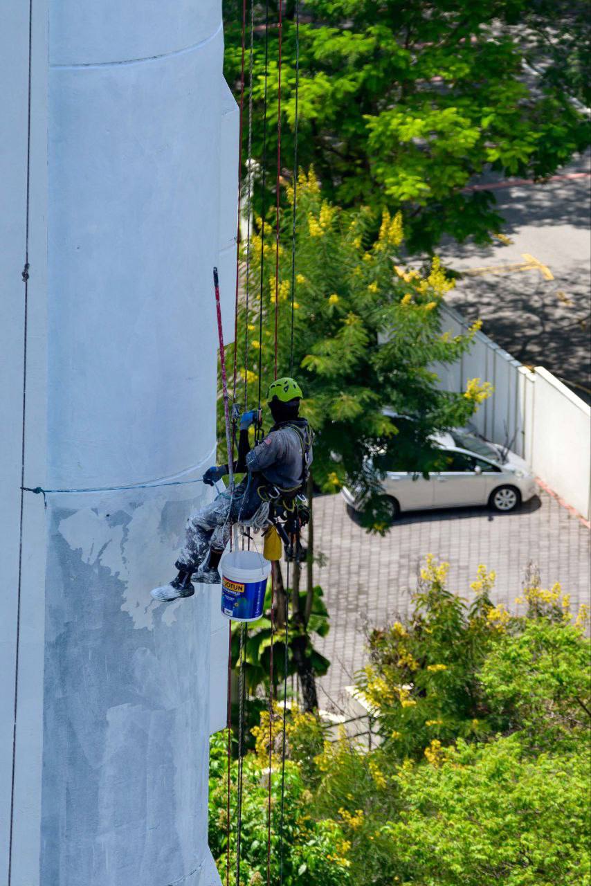 High-rise building cleaning by rope access technicians